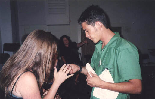 Artists Brandie Maddalena and Eric Wong passing around Jeremiah Madon's eye lashes